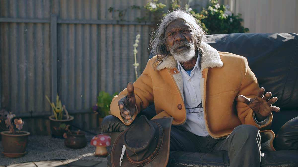 david gulpilil talking orange jacket