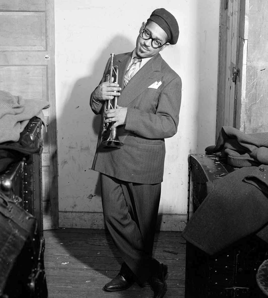 The iconic Dizzy Gillespie in a zoot suit, thick-rimmed glasses, and beret, with his trademark goatee, 1947