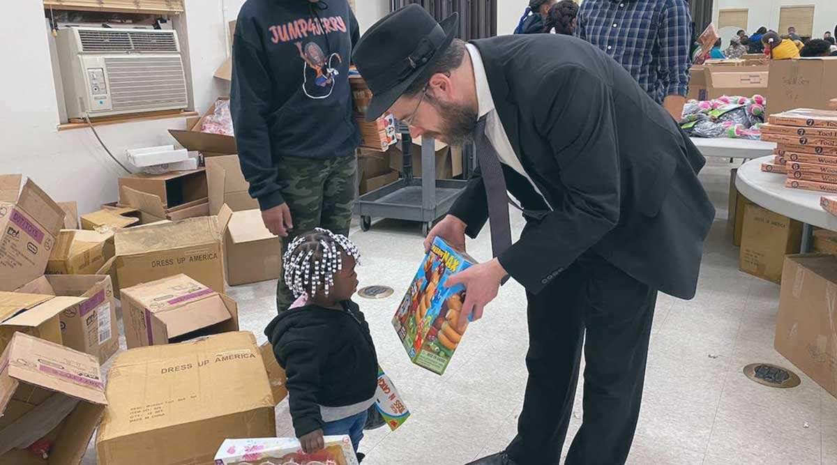 hasidic judaism man giving toy to child