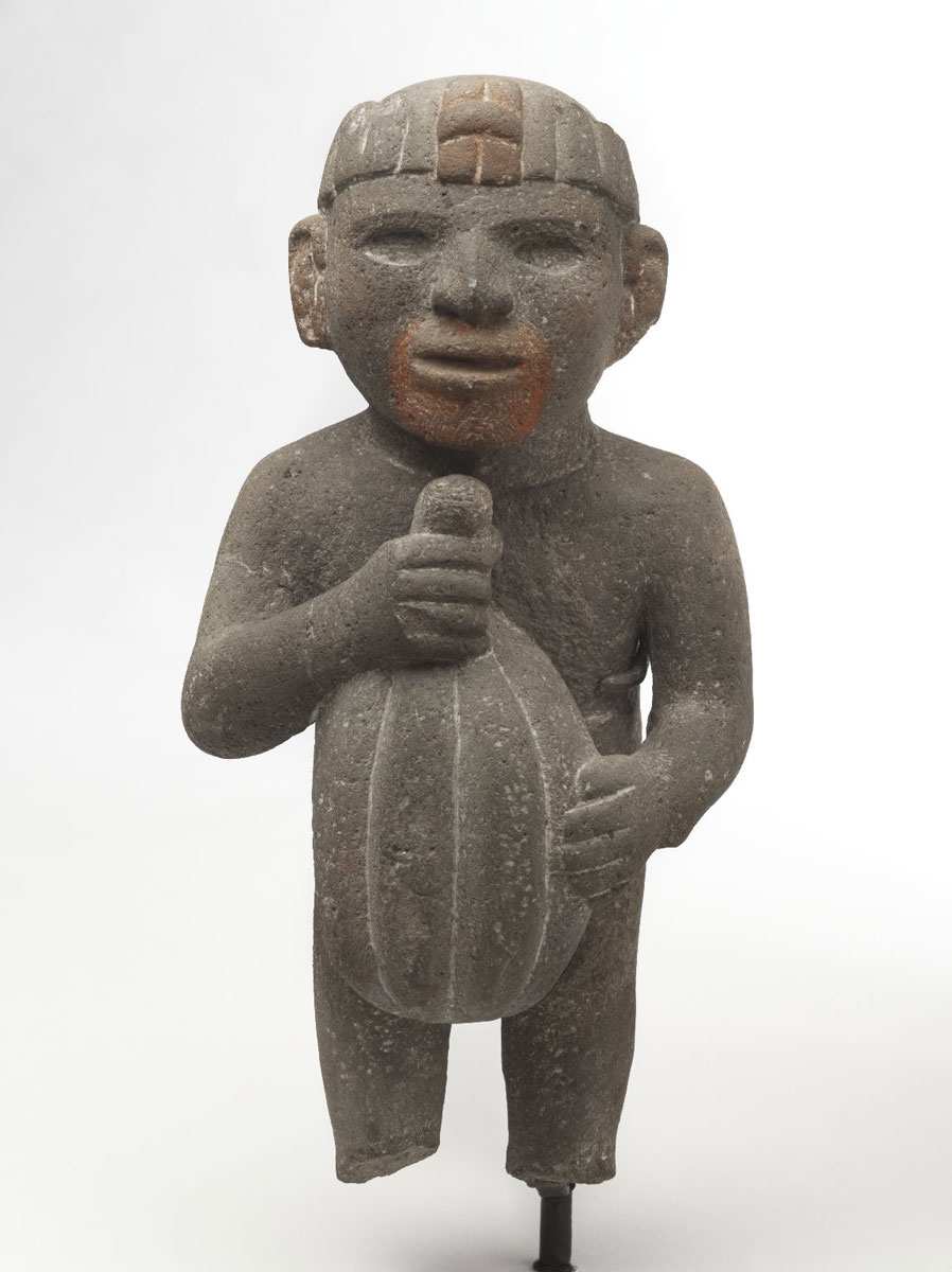 man carrying cacao pod aztec art