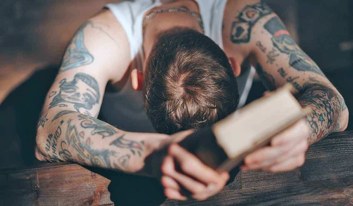 tattooed man with bible